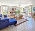 tiled floor, blue sofa, coffee table, bookshelf, fireplace, balcony