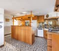 modern design kitchen, wooden cabinets, granite countertops, stainless steel appliances, island with bar stools
