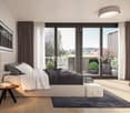 Spacious bedroom with large windows overlooking a balcony and scenic outdoor view, dark curtains, light-colored bedding, wooden side table, and potted plants on the balcony