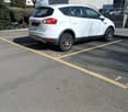 white car parked in the parking space with number 11