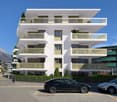 Modern residential building with multiple balconies on each floor