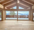 wooden floor, large windows, balcony, glass doors, wooden beams, view