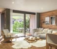 Living room with wooden wall, sliding glass door, wooden table, chairs, sofa, lamps, potted plant, sheepskin rug