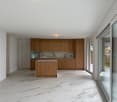 modern kitchen, wooden cabinets, marble countertop, large windows, white marble flooring