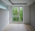 empty room, white walls, wooden floor, large window, glass door, white ceiling, built-in wardrobes