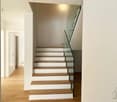 Modern staircase with wooden steps and glass railings