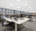 open space office, modern furniture, multiple desks, monitors, glass windows, ceiling lights