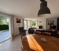 tiled floor, dining table, sofa, armchair, TV, lamp, fireplace, sliding doors leading to terrace