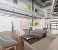 Open concept office space with hardwood floors, white walls, glass partitions, modern furniture including sofas, armchairs, and a coffee table, and decorative plants