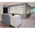modern reception area with desk, chairs, and lamp, enclosed booths, whiteboard, Regus logo