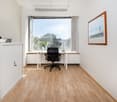 minimalist office, desk, office chair, vase, painting, storage cabinet