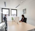 modern office space, large windows, desk, chairs, modern furniture, plants