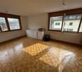 empty room, wooden parquet floor, large windows, white cabinets, radiators, wooden cabinet