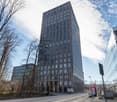 high-rise office building, modern design, multiple windows, grey exterior