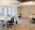 Modern office, carpeted floor, desks, chairs, trash bins, glass windows, glass doors, floor lamps