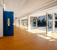Wood floor, white brick walls, glass doors, outdoor view