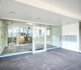 modern entrance with glass walls and doors, raised ground floor, mailbox