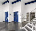 modern and clean entrance hall, raised ground floor, marble floors, blue elevators, staircase