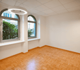 Wooden floors, white walls, arched windows, modern light fixtures, minimalistic
