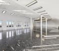 Spacious room with high ceilings, modern architectural design, large glass windows, marble floor, and recessed lighting.