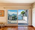 wood floor, sliding doors, balcony, painting on wall, bench, radiator, radiator