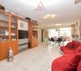 white tiles, modern furniture, red couches, television, cupboard, dining table with chairs