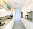 modern kitchen, granite countertop, stainless steel appliances, white cabinets, tile flooring