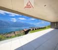 a balcony with panoramic view of the mountains and lake