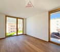empty room, large windows, hardwood floors, views of nearby buildings