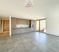 open space, modern kitchen, tiled floor, sliding glass door to the patio