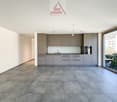 open plan kitchen with modern cabinets and integrated appliances, large windows, tiled flooring, no furniture