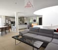 modern interior design, dining table, couch, tiled flooring, white walls, white kitchen cabinet, fridge, dartboard, staircase, windows