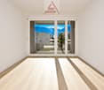 empty room with sliding glass doors leading to a balcony with mountains view