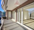 Large balcony, modern railing, sliding glass doors, hardwood flooring