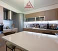 modern kitchen, wooden cabinets, white countertops, stainless steel appliances, dishwasher, washing machine