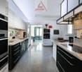 modern kitchen, granite countertops, stainless steel appliances, white cabinets, dishwasher, washing machine