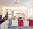 modern living room, fireplace, gray sofa, dining table, kitchen, stairs