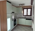 kitchen, wooden cabinets, white countertops, fridge, oven, sink, dishwasher, ceiling lamp