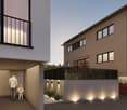Modern two-story house, beige exterior, black railings, garage, car parked, family walking