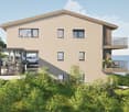 Apartement building, three stories, beige exterior, two balconies, underground parking for bicycles and cars