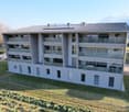 4 story building, solar panels on the roof, balconies on each floor, fenced yard