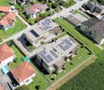 Residential housing with solar panels on roofs, surrounded by green gardens and pools, with separate roads and driveways