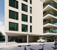 Modern apartment building, white exterior, multiple floors, glass windows, balconies, underground parking, outdoor parking area
