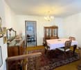 dining room with wooden table and chairs, chandelier, wooden cabinet, mirror, chandelier