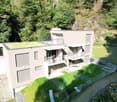 Modern house, 2 floors, green roof, balconies, fenced garden, stone wall