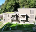 Modern house, 3 floors, green roof, balconies, fenced yard, outdoor seating area