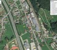 Aerial view of a town with residential buildings, a sports center, a school, a restaurant, and a police station.