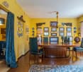 dining room, wooden table, green chairs, chandelier, yellow walls, picture frames