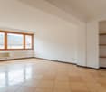 Large windows with outside view, wooden flooring, white walls, shelves, white radiators