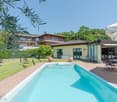 2 story house, outdoor pool, grassy garden, patio furniture